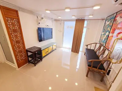a living room with a tv and a couch and a chair at Crane nest 1 Easy-peasy no stairs in Bangkok