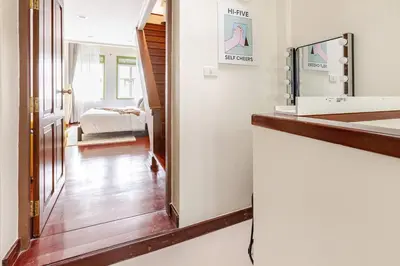 a room with a mirror and a hallway with a bed at Nueng Rana 232 Corner view 1BR Duplex 3beds / 2B in Samphanthawong