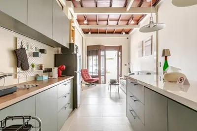 a kitchen with white cabinets and a large counter at Nueng Rana 232 Corner view 1BR Duplex 3beds / 2B in Samphanthawong