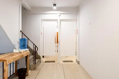 a hallway with a door in a room at XX Mitr Inn Khaosan Street - มิตร อินน์ ตรอกข้าวสาร in Bangkok