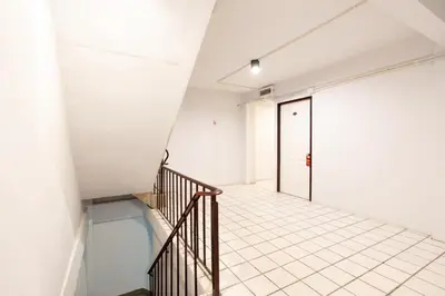 a staircase in a building with a glass floor at XX Mitr Inn Khaosan Street - มิตร อินน์ ตรอกข้าวสาร in Bangkok