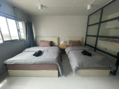 a bedroom with two beds and a window at Lazy Nest at Impact Muangthong in Thung Si Kan