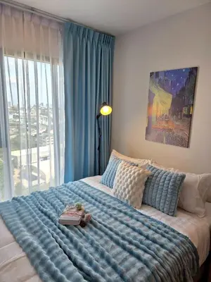 a bedroom with a large bed with a book on it at Modiz Modiza Sukhumvit R1 in Bangkok