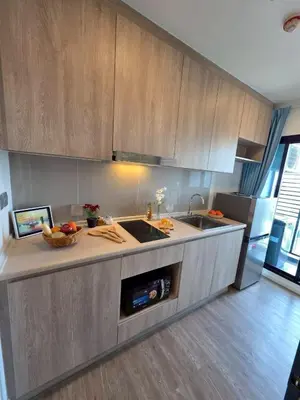 a kitchen with a sink and a counter top at Modiz Modiza Sukhumvit R1 in Bangkok