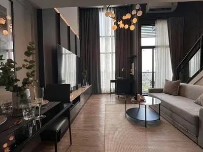 a living room with a couch and a table at Modiz Modiza Sukhumvit R2 in Bangkok