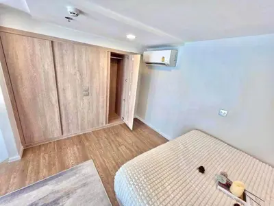 an empty room with a bed and a cabinet at Modiz Modiza Sukhumvit R3 in Bangkok