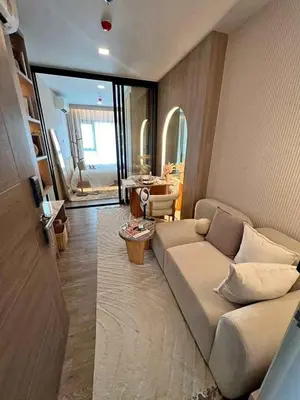 a living room with a couch and a table at Modiz Modiza Sukhumvit R5 in Bangkok