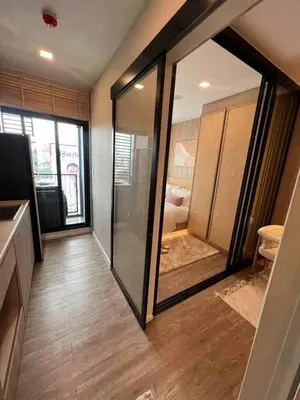 a room with a sliding glass door with a bedroom at Modiz Modiza Sukhumvit R5 in Bangkok