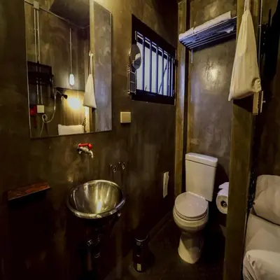 a small bathroom with a toilet and a sink at Collection O Jasaen Stylish Unique Hotel in Bangkok