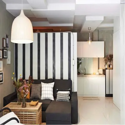 a living room with a black and white striped wall at Collection O Jasaen Stylish Unique Hotel in Bangkok