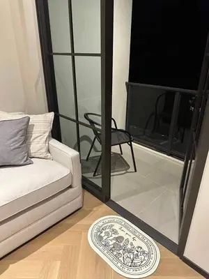 a living room with a couch and a plate on the floor at Luxury condominium Heart of BKK Ekkamai in Bangkok