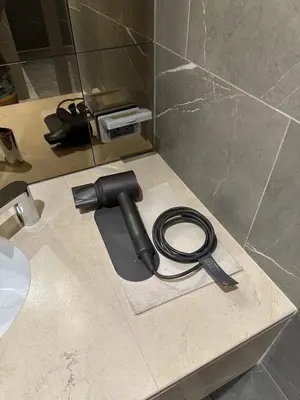 a hose laying on a counter next to a toilet at Luxury condominium Heart of BKK Ekkamai in Bangkok