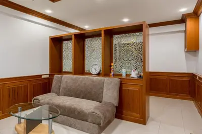 a living room with a couch and a glass table at White Base in Bangkok