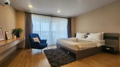 a bedroom with a bed and a blue chair at Floating Above Bangkok Same buiding of Lebua High Floor Dream near Iconsiam Asiatique in Bangkok
