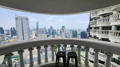 two chairs on a balcony with a view of a city at Floating Above Bangkok Same buiding of Lebua High Floor Dream near Iconsiam Asiatique in Bangkok