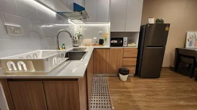 a kitchen with a sink and a refrigerator at Floating Above Bangkok Same buiding of Lebua High Floor Dream near Iconsiam Asiatique in Bangkok