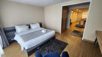 a bedroom with a large bed and a living room at Floating Above Bangkok Same buiding of Lebua High Floor Dream near Iconsiam Asiatique in Bangkok