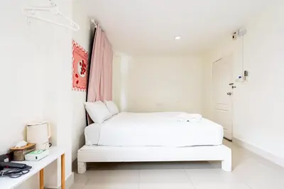 a white bedroom with a white bed in it at XX Oh My Nap Nana Soi 3 - BTS Nana in Bangkok