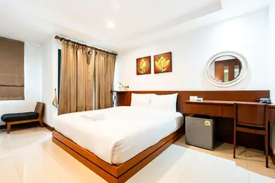 a hotel room with a bed and a desk at XX Yon INN Sukhumvit Soi 4 BTS Nana in Bangkok