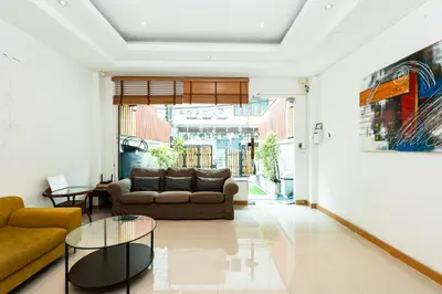 a living room with a couch and a table at XX Yon INN Sukhumvit Soi 4 BTS Nana in Bangkok
