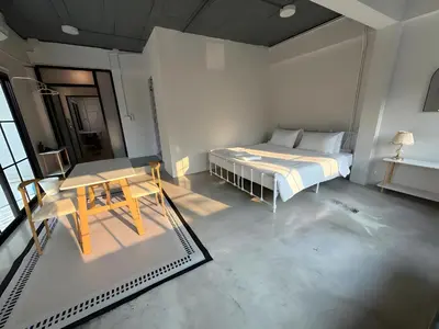 a bedroom with a bed and a table in it at xx Yellow Place Sukhumvit Soi 2 - เยลโล เพลส สุขุมวิทซอย 2 in Bang Kapi