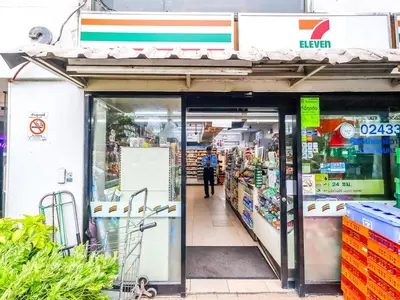 a store entrance to a store with a person walking into it at Studio room with private garden in Center Sathorn in Bangkok