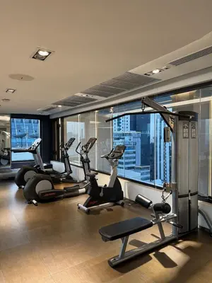 a gym with several tread machines and a view of a city at Downtown Luxury Apartment, Asok Cowboy Lane, 400m from BTS in Bangkok
