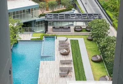 an overhead view of a building with a swimming pool at 1 Bedroom Bangkok Skyline View Apartment At ON-NUT in Bangkok