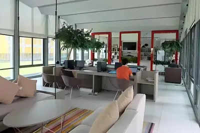 a person sitting at a table in an office at Skyline View 1 Bedroom Near RCA, Thonglor And Nana in Bangkok