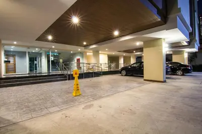a parking lot with cars parked in a parking garage at Dae Ma Place in Nonthaburi