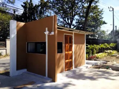 a small house with a tv on the side of it at Dae Ma Place in Nonthaburi