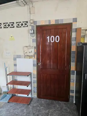 a wooden door with the number in front of it at 100 Luxury Studio Apartment with private balcony in Bangkok