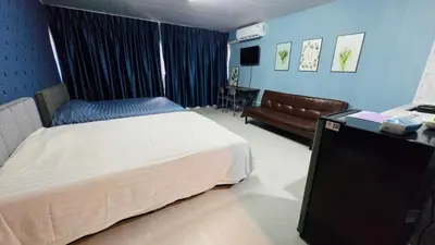 a hotel room with a bed and a couch at อิมแพ็ค เมืองทองธานี ห้องเช่ารายวัน เมืองทอง popular condo C4 in Nonthaburi