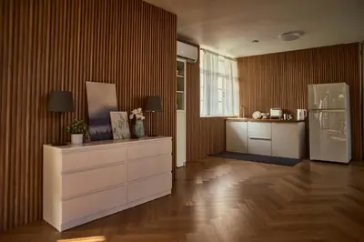 a kitchen with a refrigerator and a dresser at Baan Suanpak in Bangkok