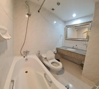 a bathroom with a tub and a toilet and a sink at Comfort 1BR 2 King Beds, Best Value Stay, near Bts Nana in Bangkok