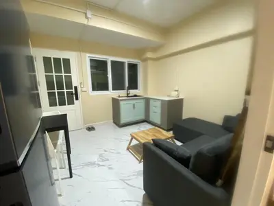 a living room with a couch and a table at 1 Bed Nr IKEA 15Mins to Airport in Bangkok