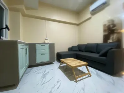 a living room with a blue couch and a table at 1 Bed Nr IKEA 15Mins to Airport in Bangkok