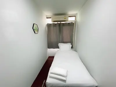 a small room with two beds in it at XX GO INN Siriraj Wang Lang - โก อินน์ โรงพยาบาลศิริราช วังหลัง in Bangkok