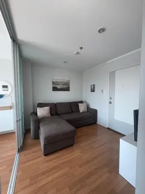 a living room with a couch and a television at Minimalist Condo in Pinklao in Bangkok