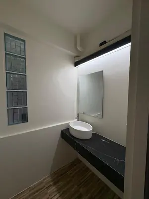 a bathroom with a sink and a mirror on a counter at The beeroom by BoonmeeApt in Sathani Sam Sen