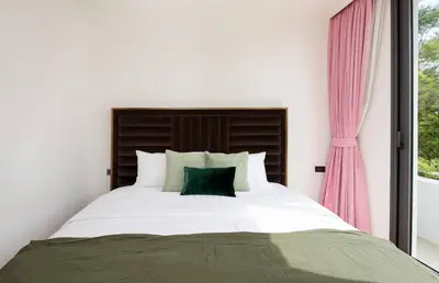 a bedroom with a large bed with a window at Modern Luxury Poolhaus with Lift in Khlong Toei