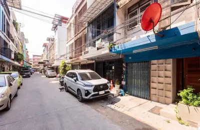 a car parked on the side of a city street at Bali Style Rooftop Apartment in Bangkok