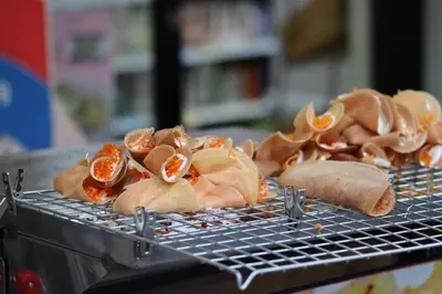 a metal grill with some food on it at SKY 21 Colorful Room with Soaring View Center BKK in Bangkok