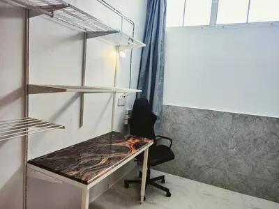 a room with a desk and a chair and shelves at Tropical Apartments 1 No Stairs easy peasy in Bangkok