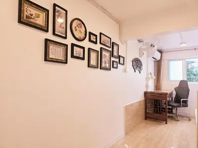 a room with a wall with many pictures on it at Crane nest 2 mezzanine opaque view in Bangkok