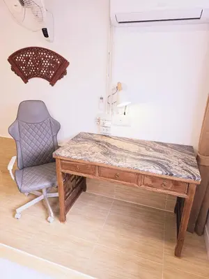 a wooden desk with a chair and a marble top at Crane nest 2 mezzanine opaque view in Bangkok