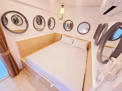 a small bed in a room with round mirrors at Crane nest 4 lower floor in Bangkok