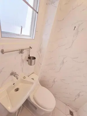 a white bathroom with a toilet and a sink at Crane nest 5 townhouses view with french balcony in Bangkok