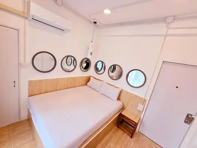 a small room with a bed and four mirrors at Crane nest 5 townhouses view with french balcony in Bangkok