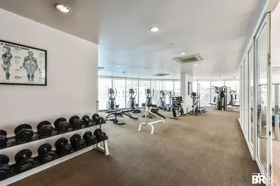 a gym with treadmills and exercise equipment in a building at New 5 STARS suite l 4 mins walk BTS&APL in Bangkok